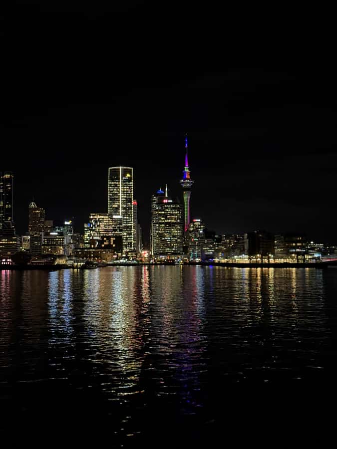 Auckland: Nightlights Harbour Cruise with Canapés and Drink - The first hour: sunset, water, and city lights